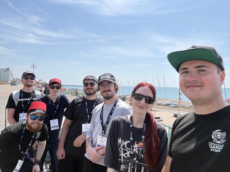 Four members of the Shiverbug Studios team on Brighton seafront during Develop:Brighton